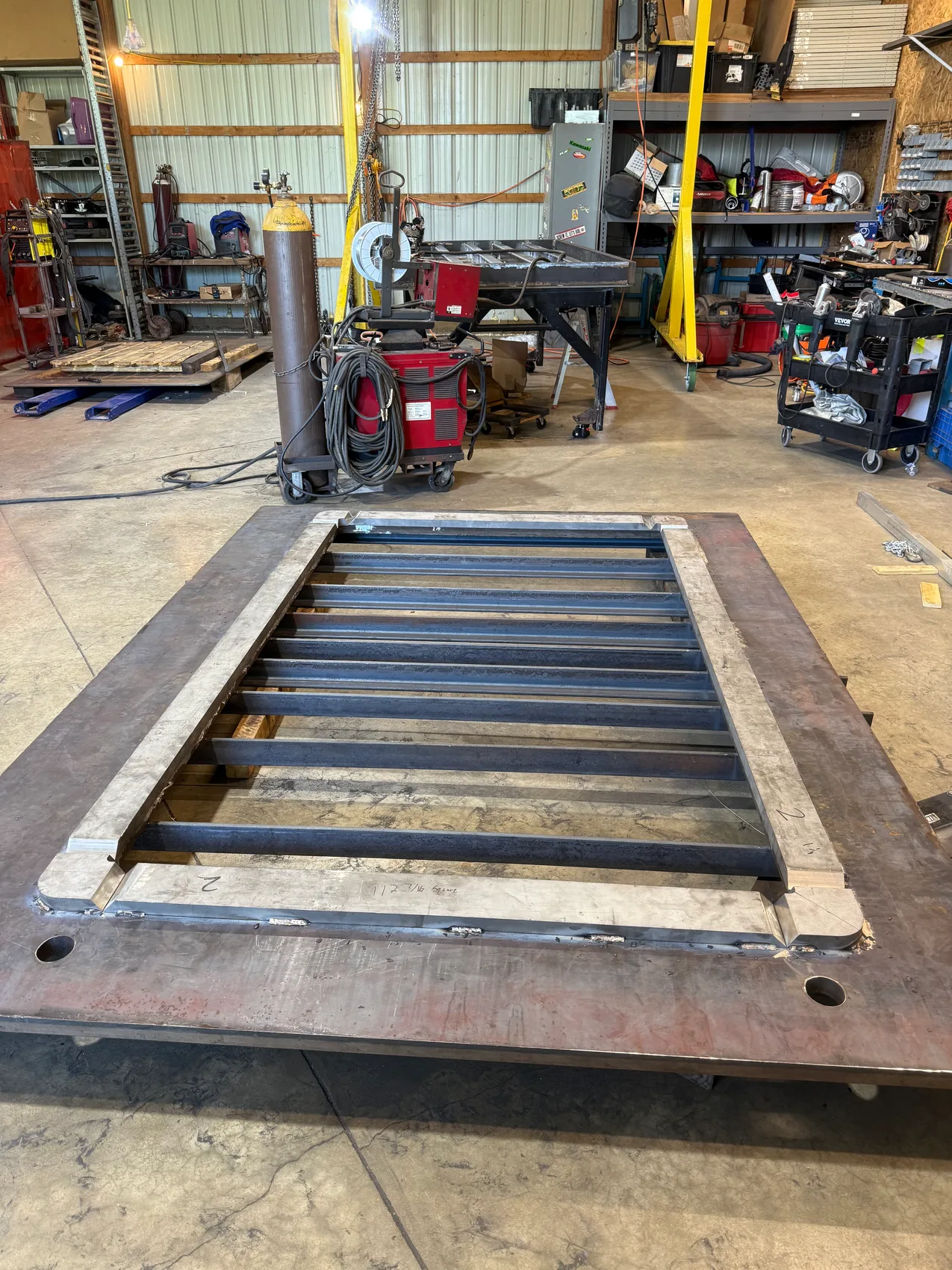 The cross-ribbed skeleton before skinning - every cell fit and tacked so the finished door seals water-tight.