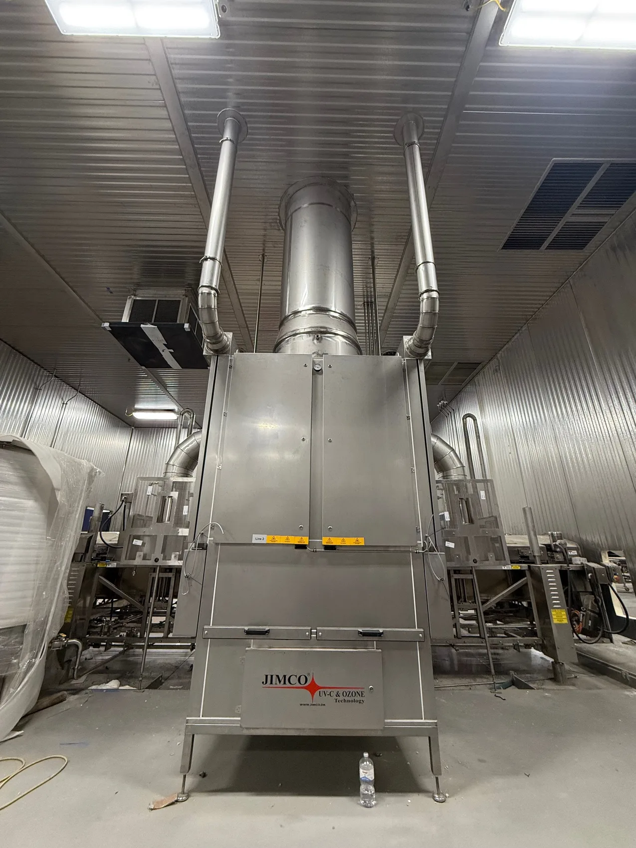 The JIMCO UV-C / ozone unit tied into the spiral stainless exhaust - the heart of the air-treatment system.